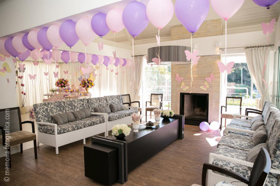 party room decorated with balloons with strings of butterflies