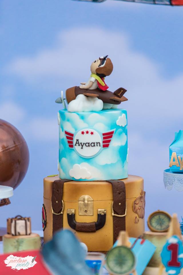 airplane cake luggage and clouds